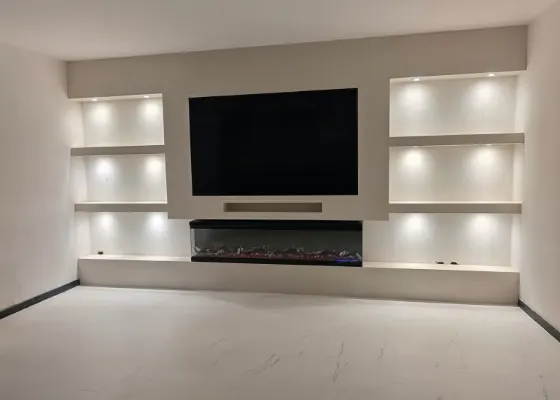 Cinewall met sfeerhaard, soundbarvak en verlichte vakken, voorbeeld van cinewallcenter